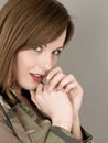 Portrait of a Woman a Military Camouflage Jacket Looking Shy and