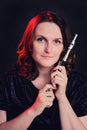 Portrait of a woman musician with a piccolo flute on a studio black background. Flutist with a small flute in her hands Royalty Free Stock Photo