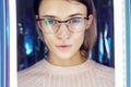 Portrait of a woman in neon colored reflection glasses in the background. Good vision, perfect makeup on girl face. Art portrait