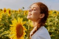 portrait of woman with pigtails in nature field in sunflower posing Royalty Free Stock Photo