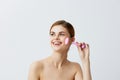 portrait woman pink quartz roller skin care massage bare shoulders close-up Lifestyle