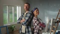 Portrait of woman in pink rubber gloves and man is crossing their arms, looking seriously at camera and smiling. Young Royalty Free Stock Photo