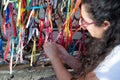 Portrait of a woman placing colored ribbons on the church grid Royalty Free Stock Photo