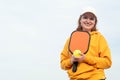 portrait woman player pickleball game over blue sky, pickleball yellow ball with paddle, outdoor sport leisure activity.