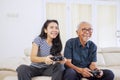 Portrait of woman playing game with her old father Royalty Free Stock Photo