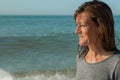 Portrait of woman in profile looking at the sea and smiling, sea bed Royalty Free Stock Photo