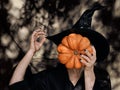 Portrait of woman pumpkin faceless on dark background for celebration design. Autumn holiday fun. Happy halloween