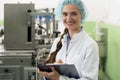 Portrait of woman quality inspector during work in cosmetics factory