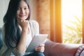 Portrait of woman reading a magazine online on tablet at coffee cafe Royalty Free Stock Photo