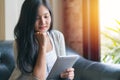 Portrait of woman reading a magazine online on tablet at coffee cafe Royalty Free Stock Photo