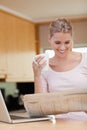 Portrait of a woman reading the news while having tea Royalty Free Stock Photo