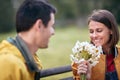 Portrait of a woman receiving a bouquet of flowers; Inlove couple concept Royalty Free Stock Photo