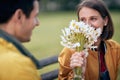 Portrait of a woman receiving a bouquet of flowers; Inlove couple concept