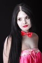 Portrait of a woman in a red bow-tie covered by white powder Royalty Free Stock Photo