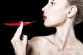 Portrait of the woman with red lips and red burning pepper Royalty Free Stock Photo
