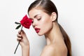 Portrait of woman Red lips nude model shoulders with rose bright makeup