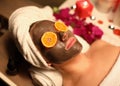 Portrait of woman with a rejuvenating face mask and orange slices on her eyes Royalty Free Stock Photo