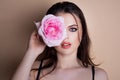 Portrait of a woman with a rose flower. Beauty fashion model woman face. Portrait of a beautiful young girl with a pink Royalty Free Stock Photo