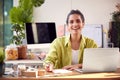 Portrait Of Woman Running Online Business Making Boutique Candles At Home Working On Laptop Royalty Free Stock Photo