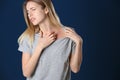 Portrait of woman scratching neck, space for text. Allergy symptom