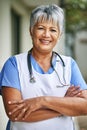 Portrait, woman and senior nurse with pride outdoor for healthcare, hospice and sick. Medical care, stethoscope and face