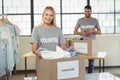 Portrait of woman separating clothes from donation box Royalty Free Stock Photo