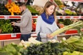 Portrait of woman shopping fresh celery in shop