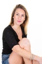 Portrait Of Woman Sitting floor Against White Wall background Royalty Free Stock Photo