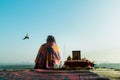 A portrait of a woman sitting on the Ghats