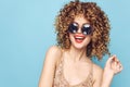 Portrait of a woman smile round sunglasses curly hair fun tshirt