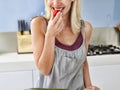 Portrait of Woman Snacking in Kitchen