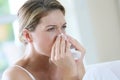 Portrait of a woman sneezing and blowing her nose Royalty Free Stock Photo