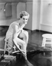 Portrait of woman soaking feet in footbath