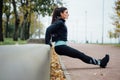 Portrait of woman in sportswear, doing fitness push-ups exercise at fall park, outdoor. Royalty Free Stock Photo