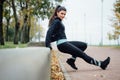 Portrait of woman in sportswear, doing fitness push-ups exercise at fall park, outdoor. Royalty Free Stock Photo