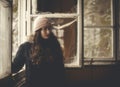 Portrait of a woman standing by the window in abandoned building.Urban exploration concept. Royalty Free Stock Photo