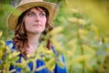 Portrait of a woman in a straw hat on a willow background Royalty Free Stock Photo