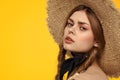 Portrait woman in straw hat on yellow background cropped view of summer dress model pigtails romance