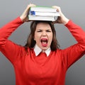 Portrait of woman student tired of learning against gray background