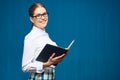 Portrait of woman student wearing glasses holding open book Royalty Free Stock Photo