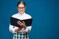 Portrait of woman student wearing glasses reading book Royalty Free Stock Photo