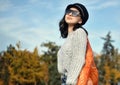 Portrait of a woman in sunglasses holding a string bag and paper cup of coffee Royalty Free Stock Photo