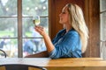 A woman enjoying a delicious craft beer pint in a tulip glass at a bar, pub, restaurant, during weekend