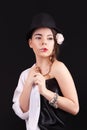 Portrait of the woman with a theatrical makeup on black background