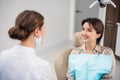 A portrait of a woman with a toothy smile sitting on the dental Royalty Free Stock Photo