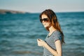 portrait of woman tourism travel sea mountains in the background and glasses on the face