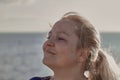 Portrait of a woman tourist on a cruise liner ship breathes fresh sea air Royalty Free Stock Photo