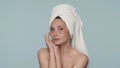 Portrait of a woman with a towel on her head and red hydrogel patches under her eyes close up. A woman enjoys the purity Royalty Free Stock Photo