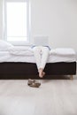 Woman using laptop on her bed Royalty Free Stock Photo