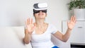 Portrait of woman using virtual reality gogles watching 360 degree video at home